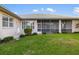 The exterior features a screened-in porch and manicured lawn at 664 Silk Oak Dr, Venice, FL 34293