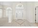 Foyer features a decorative tile inlay, complemented by ample natural light and neutral walls at 664 Silk Oak Dr, Venice, FL 34293