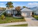 This single-story home has a neutral exterior, a white roof and a two-car garage at 664 Silk Oak Dr, Venice, FL 34293