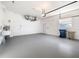 A large garage featuring a ceiling fan, utility sink, and epoxy floors at 664 Silk Oak Dr, Venice, FL 34293