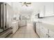 Spacious kitchen with white cabinets, tile floor, and a stainless steel refrigerator at 664 Silk Oak Dr, Venice, FL 34293