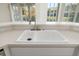 Kitchen sink with a stainless steel faucet and white countertops at 664 Silk Oak Dr, Venice, FL 34293
