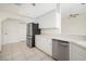 Bright kitchen featuring stainless steel appliances, white cabinetry, and tile flooring at 664 Silk Oak Dr, Venice, FL 34293