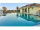 Community pool with a building and palm trees reflecting in the water at 664 Silk Oak Dr, Venice, FL 34293