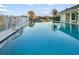Community pool with lounge seating and a building that is partially visible at 664 Silk Oak Dr, Venice, FL 34293