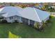 An aerial view of a screened in lanai, with a well maintained lawn at 664 Silk Oak Dr, Venice, FL 34293