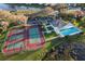 An aerial photograph depicts tennis courts and a pool in a well maintained recreation area at 664 Silk Oak Dr, Venice, FL 34293