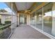 This screened porch features tile flooring and multiple sliding glass doors at 664 Silk Oak Dr, Venice, FL 34293