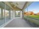 This screened porch features tile flooring and an overhead fan for comfortable outdoor living at 664 Silk Oak Dr, Venice, FL 34293