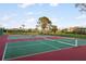 A view of outdoor tennis courts with surrounding residential homes at 664 Silk Oak Dr, Venice, FL 34293