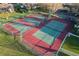 Aerial view of tennis and pickleball courts in a well-maintained community at 664 Silk Oak Dr, Venice, FL 34293