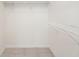 This walk-in closet features white wire shelving and tiled floors, ready for organization at 664 Silk Oak Dr, Venice, FL 34293