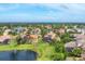 Aerial shot of a pond in the neighborhood with palm tree landscaping at 6822 Dominion Ln, Lakewood Ranch, FL 34202