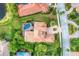 A luxurious home with a red tile roof, manicured landscaping, private pool, and backyard lake access at 6822 Dominion Ln, Lakewood Ranch, FL 34202