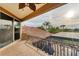 A balcony with decorative railings overlooking the pool, roof, and palm trees at 6822 Dominion Ln, Lakewood Ranch, FL 34202
