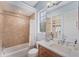 A modern bathroom featuring a shower/tub combo and a vanity with generous counter space at 6822 Dominion Ln, Lakewood Ranch, FL 34202