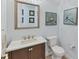 Powder room with vanity, stone countertop, mirror, and decorative artwork on the wall at 6822 Dominion Ln, Lakewood Ranch, FL 34202