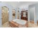 A spacious bathroom featuring a bathtub, walk-in shower, and custom mosaic details at 6822 Dominion Ln, Lakewood Ranch, FL 34202