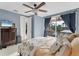 Cozy bedroom with a ceiling fan, an area rug, and an exterior view of a covered patio at 6822 Dominion Ln, Lakewood Ranch, FL 34202