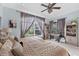 A bright bedroom with a full-sized bed, large windows, and built-in shelves at 6822 Dominion Ln, Lakewood Ranch, FL 34202