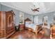 A luxurious bedroom featuring hardwood floors, a ceiling fan and a spacious layout at 6822 Dominion Ln, Lakewood Ranch, FL 34202