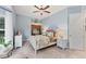 A peaceful bedroom with a bay window, ceiling fan, and built-in desk at 6822 Dominion Ln, Lakewood Ranch, FL 34202