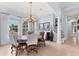 Charming dining room with a round table, elegant chandelier, and large windows offering plenty of light at 6822 Dominion Ln, Lakewood Ranch, FL 34202