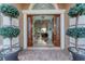 Grand entrance featuring double doors, tile flooring, and views into the spacious living room at 6822 Dominion Ln, Lakewood Ranch, FL 34202