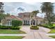 Beautiful two-story home boasts meticulously manicured landscaping and a circular driveway at 6822 Dominion Ln, Lakewood Ranch, FL 34202