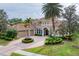 Elegant home featuring a terracotta roof, manicured front lawn, circular driveway and three car garage at 6822 Dominion Ln, Lakewood Ranch, FL 34202