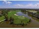 Picture of a lush golf course with water features and sand traps surrounded by trees and neighborhood at 6822 Dominion Ln, Lakewood Ranch, FL 34202