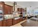 Chef's kitchen with custom cabinets, granite countertops, a gas range, and stainless steel appliances at 6822 Dominion Ln, Lakewood Ranch, FL 34202