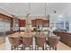 Gourmet kitchen featuring a center island with seating, stainless steel appliances, and custom cabinetry at 6822 Dominion Ln, Lakewood Ranch, FL 34202