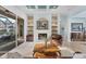 Beautiful living room featuring a fireplace, built-in shelving, and sliding doors to the outdoor space at 6822 Dominion Ln, Lakewood Ranch, FL 34202