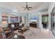 The living room has a large leather sofa, decorative ceiling, and access to the lanai at 6822 Dominion Ln, Lakewood Ranch, FL 34202