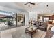 Open-concept living area flows to outdoor spaces through walls of glass windows and doors at 6822 Dominion Ln, Lakewood Ranch, FL 34202