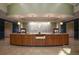 The lobby boasts a reception desk made of hardwood and stone, modern lighting, and a decorative tile backsplash at 6822 Dominion Ln, Lakewood Ranch, FL 34202