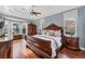 Elegant main bedroom features hardwood floors, tray ceiling, and large windows at 6822 Dominion Ln, Lakewood Ranch, FL 34202