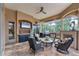 Lovely outdoor living space complete with brick floors, a fireplace, and a ceiling fan at 6822 Dominion Ln, Lakewood Ranch, FL 34202