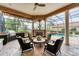 Inviting screened-in patio features a fireplace, outdoor kitchen, and comfortable seating by the pool at 6822 Dominion Ln, Lakewood Ranch, FL 34202