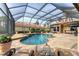 Relaxing screened-in pool and spa area featuring a brick patio and plenty of seating at 6822 Dominion Ln, Lakewood Ranch, FL 34202