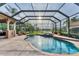 An in-ground pool and hot tub are encased with a screen providing a gorgeous outdoor experience at 6822 Dominion Ln, Lakewood Ranch, FL 34202