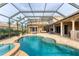 Beautiful screened-in pool with an attached spa and outdoor patio area for entertaining at 6822 Dominion Ln, Lakewood Ranch, FL 34202