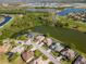Expansive aerial view of a residential community with lakefront properties and a golf course in the vicinity at 711 Planters Manor Way, Bradenton, FL 34212