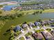 Stunning aerial view of homes next to a lake and golf course, capturing the essence of resort-style living at 711 Planters Manor Way, Bradenton, FL 34212