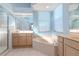Spa-like bathroom featuring a luxurious soaking tub, walk-in shower, and double vanity at 711 Planters Manor Way, Bradenton, FL 34212