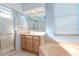 Bright bathroom featuring a shower with glass doors, vanity with mirror and soaking tub at 711 Planters Manor Way, Bradenton, FL 34212