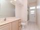 Practical bathroom with a toilet, sink, vanity and shower with glass door providing natural light at 711 Planters Manor Way, Bradenton, FL 34212