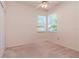 Bright bedroom featuring neutral carpet, two windows, and a ceiling fan at 711 Planters Manor Way, Bradenton, FL 34212