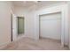 Open bedroom space with neutral carpet and a closet with bi-fold doors at 711 Planters Manor Way, Bradenton, FL 34212